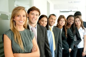 group of business people smiling in an office lined up
