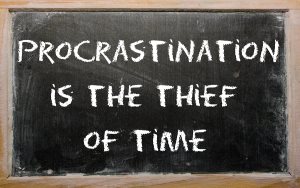 Blackboard writings "Procrastination is the thief of time"
