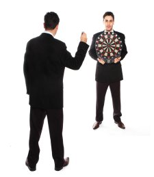 businessman is throwing a dart to a dart board