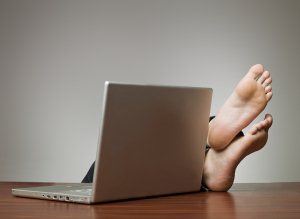 Lazy man at the office with a computer