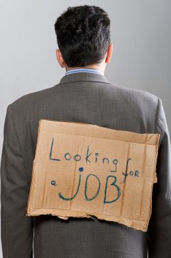 Man with cardboard job sign on back