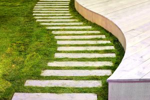 Curved garden path with green grass surface