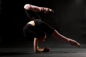 Flexible woman against black background