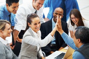 Business woman high fiving colleague during meeting
