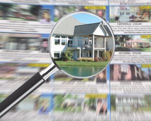 Magnifying glass over real estate ad