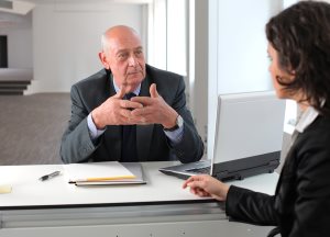 Older man talking with businesswoman
