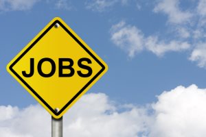 Yellow JOBS sign, blue sky background