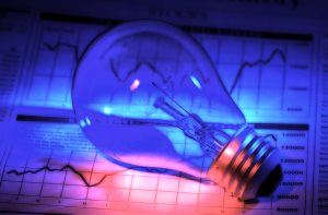 lightbulb and stock charts with colored gel lighting