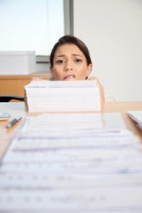 woman-behind-stack-of-papers