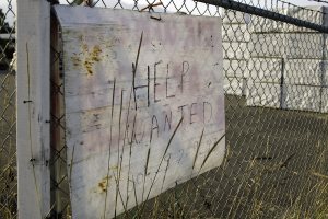 Hand-written help-wanted sign on a fence
