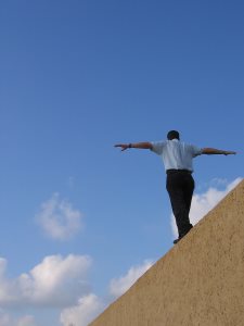 man keeping balance on a wall