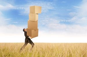 Businessman Carrying Heavy Boxes Outdoors
