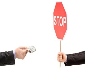 Man with a stop sign saying no to bribery