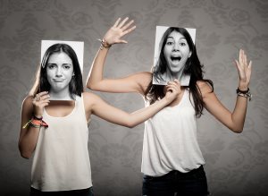 portrait of two girls holding a photography in front of face