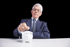 Senior businessman saving some money for his retirement