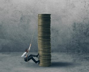 Businessman rope climbing stack of coins