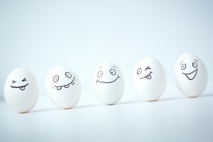 Line of Easter eggs with different facial expressions 