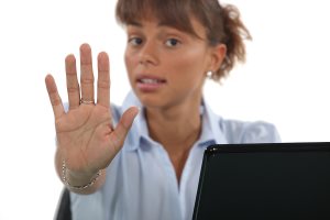 Woman holding up her hand to say stop