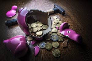 cracked pink pig moneybox with hammer