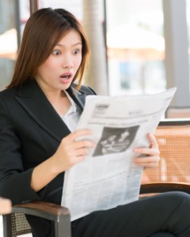 Businesswoman shocked at her newspaper