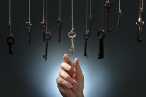 Hand choosing a hanging key amongst other ones