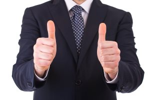 Business man showing thumbs up sign