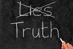 Crossing Out Lies And Writing Truth On A Blackboard