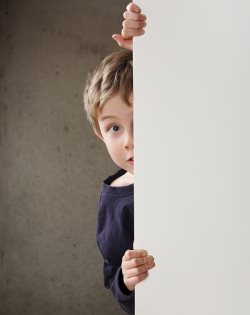 Boy Peeking around a wall