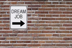 Dream Job sign mounted on a brick wall