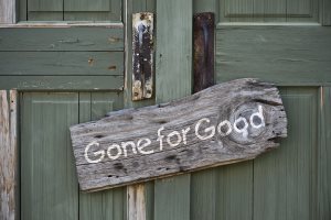 Old antique sign on doorway that says gone for good