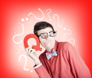 Smart thinking man with q for question mark on red background