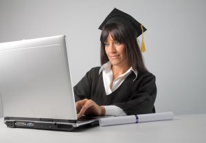 female graduate working with laptop