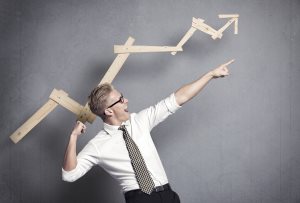 businessman pointing arm upwards in front of ascending business graph