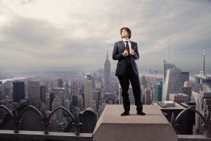 Businessman standing on the rooftop of a skyscraper