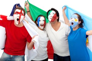 Group of excited football fans with painted faces