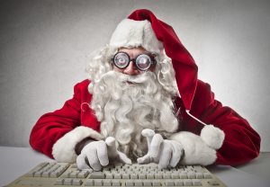 nerd Santa Claus writes with keyboard