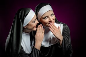 Nun Whispering A Secret To Another Nun