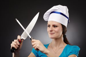 Woman Chef Sharpening The Knife