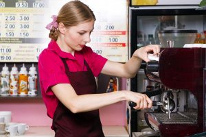 waitress making coffee at coffee machine