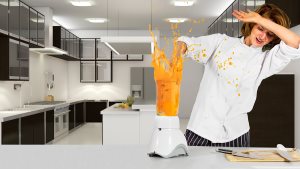 female chef making a mess with a blender