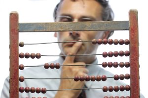 a pensive accountant with an old abacus