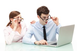 Shocked couple in front of laptop