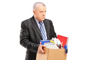 fired professional man with a box of belongings