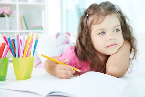 girl drawing with colorful pencils