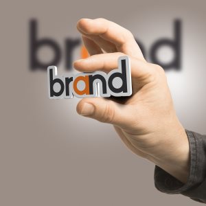 hand holding the word brand