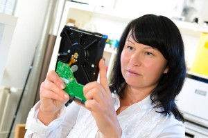 female software engineer holding disk drive