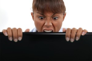 Businesswoman biting laptop screen