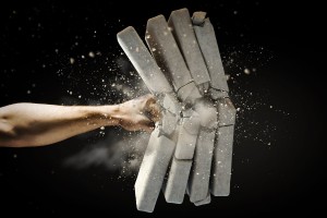 human hand breaking bricks